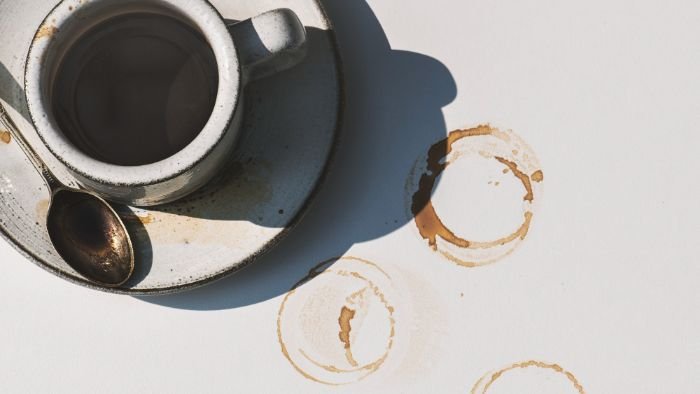 Coffee cup leaving ring stains on a white surface, illustrating common household stains and their unique chemical properties.