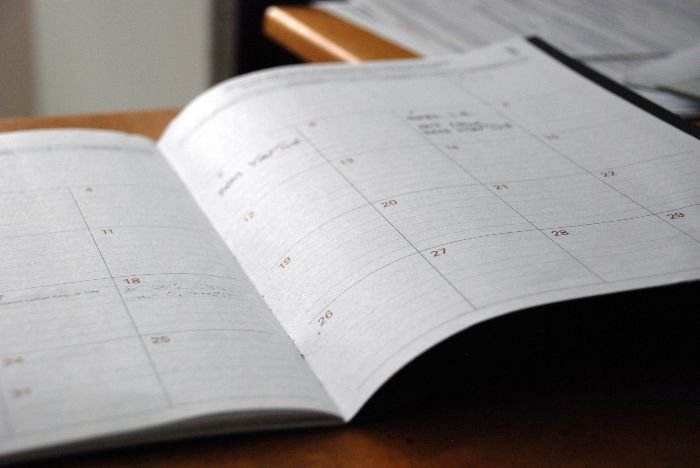 An open planner with a detailed schedule, emphasizing the importance of precise timing for cleaning sessions between guests in rental properties.