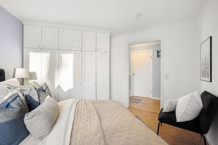 A neatly kept bedroom showcasing clean furniture and fixtures, reflecting the careful handling required during an end-of-tenancy cleaning.