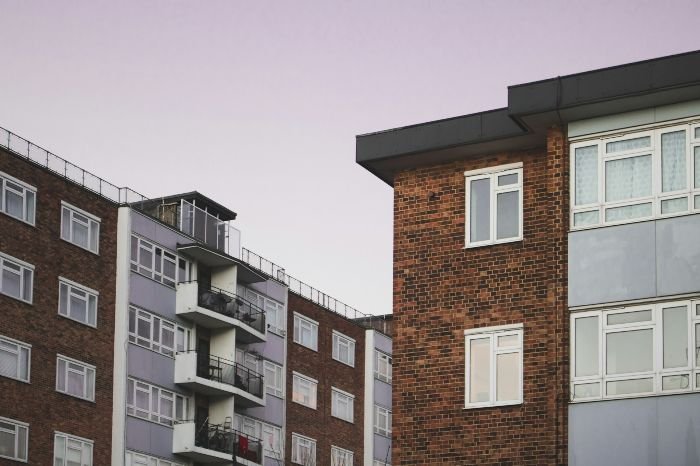 A view of a brick apartment building, highlighting the importance of hiring a professional cleaning service to maintain such rental properties.